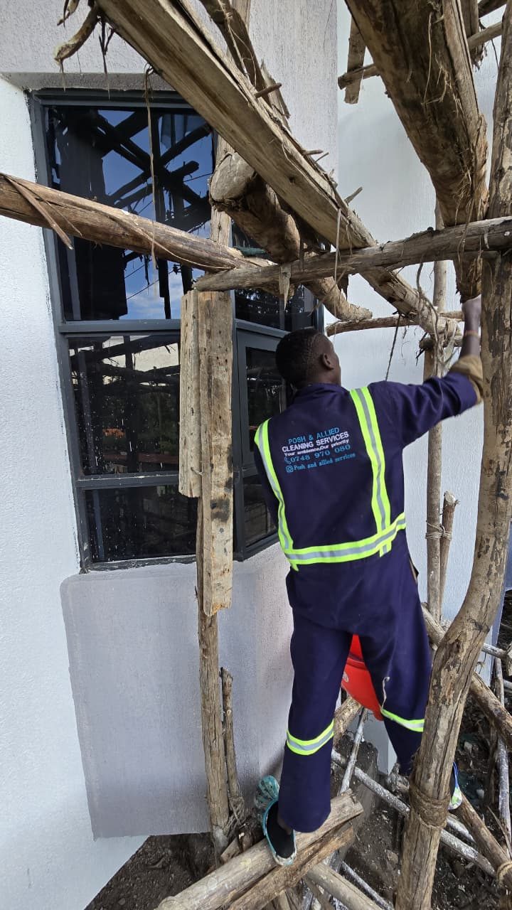 Posh & Allied technician cleaning exterior windows in Kenya